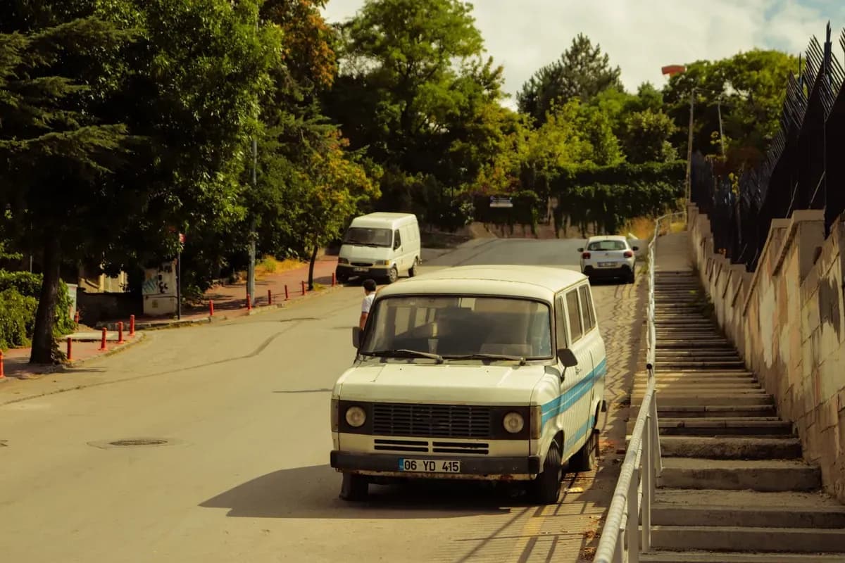 A van on a tree-lined street