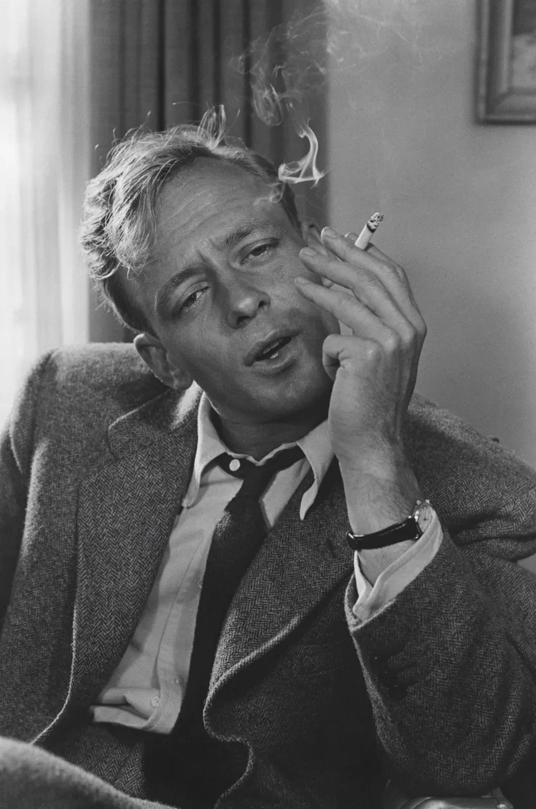 Black-and-white portrait of a man smoking a cigarette